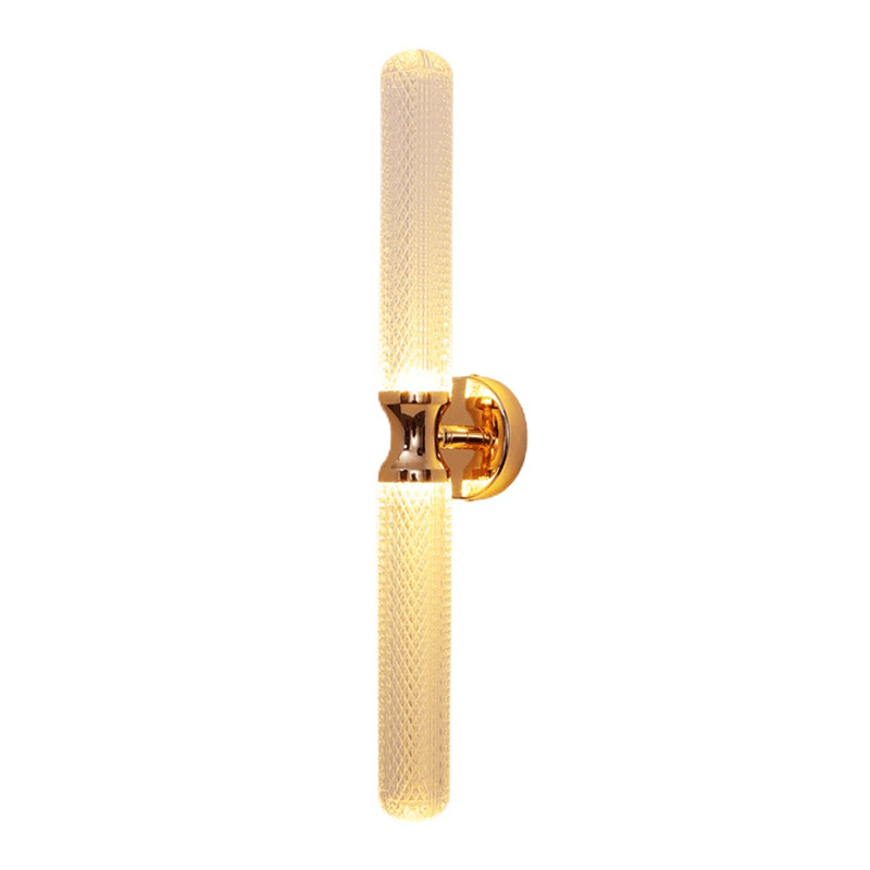 A modern wall sconce featuring a clear textured glass shade and a sleek gold fixture, designed to provide stylish illumination.