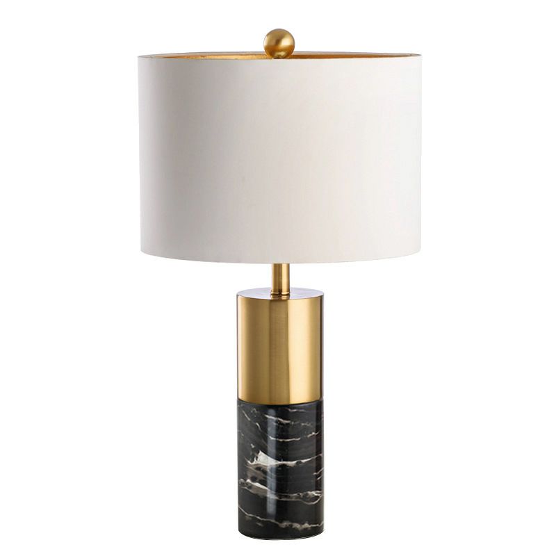 Elegant marble lamp with a gold accent and a white shade.